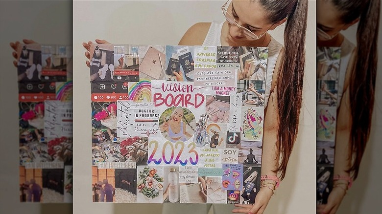 Woman holding vision board 