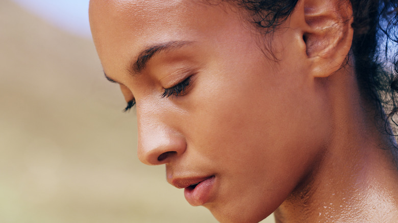woman sweating on her face