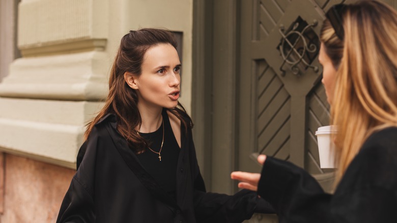 Women arguing outside door
