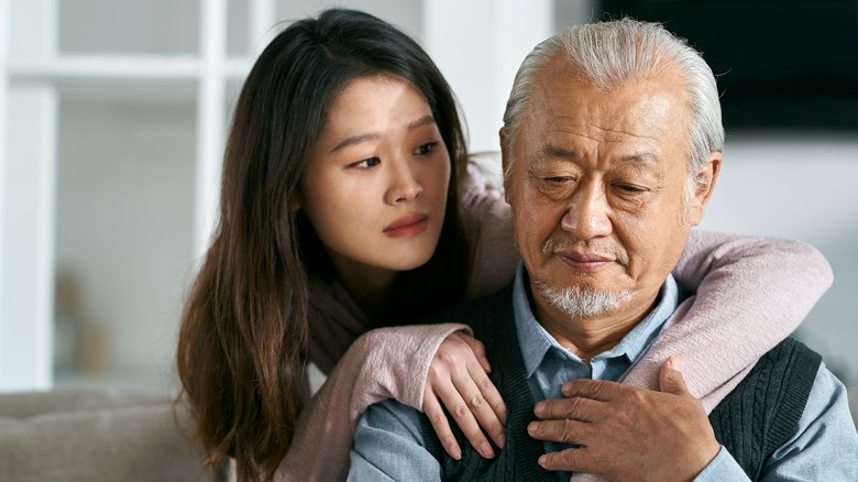 Woman hugging father