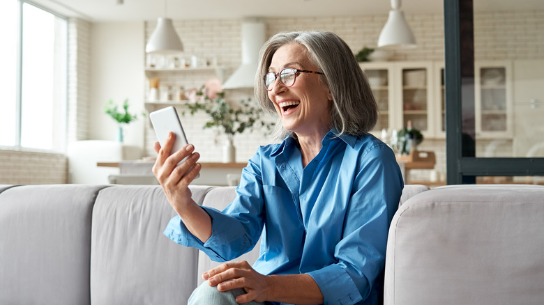Woman laughs during video call