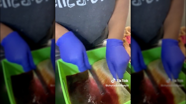 Woman dip dyeing a wig