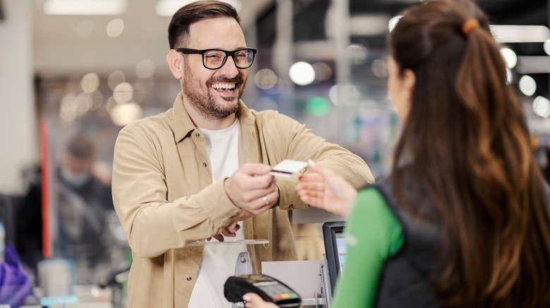 Man checks out in store