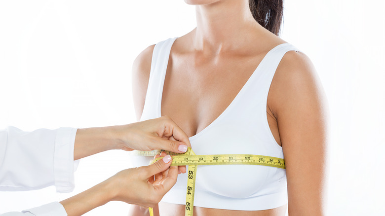 person getting bra measurement
