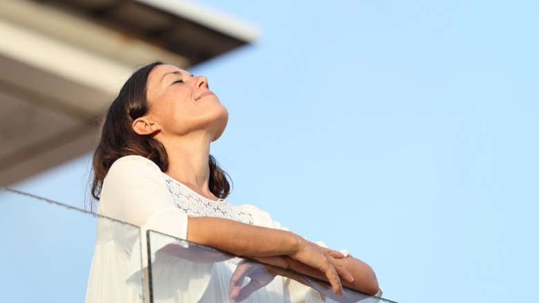 Woman looking up eyes closed