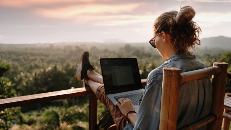 Woman working outside on balcony