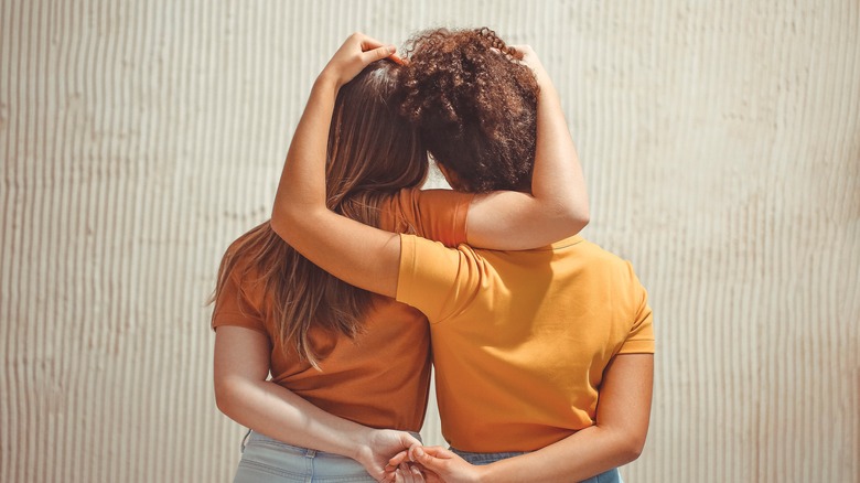 woman holding hands and heads 