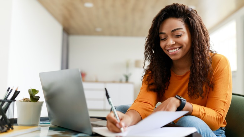 Woman writing at desk
