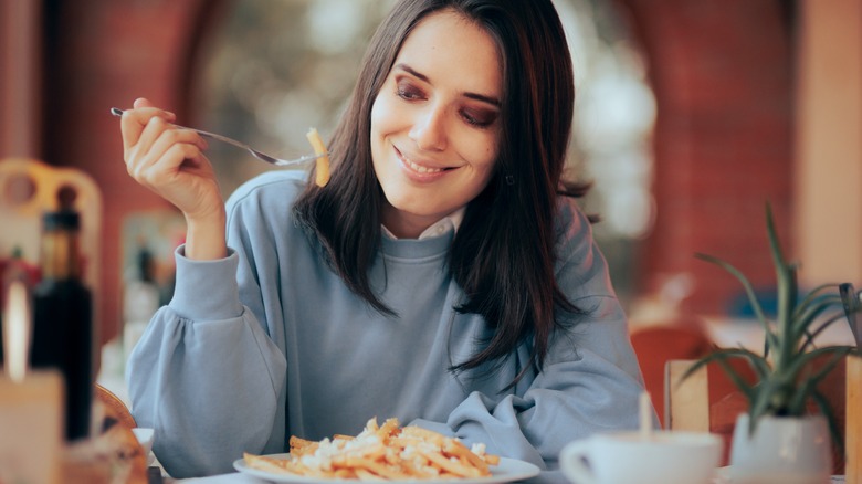 Woman enjoying french fries 