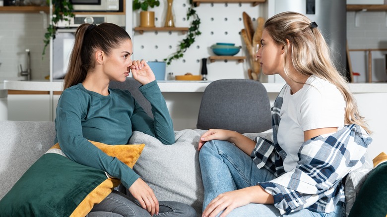 women talking on couch