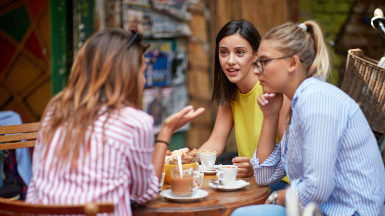 women at cafe talking