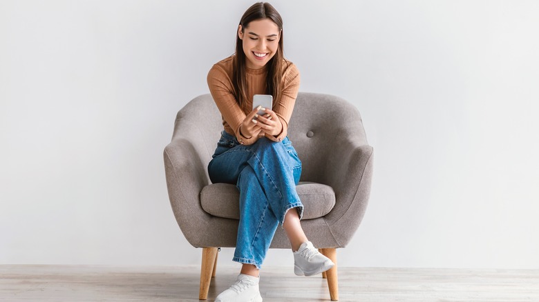 woman texting while sitting 