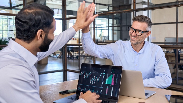Two men giving high-fives