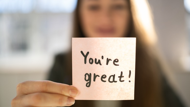 Woman holding up affirmation