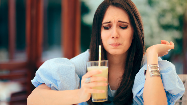 Making a face at sour drink