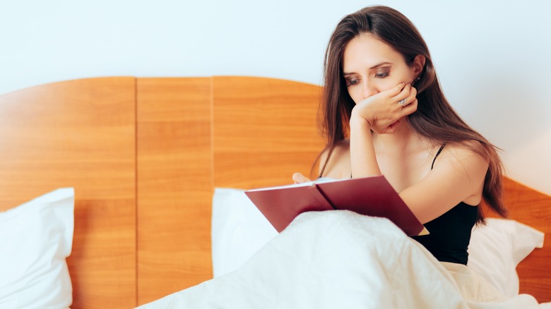 Woman journaling in bed