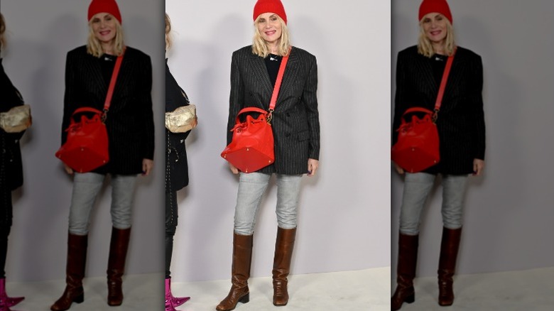 Woman wearing pinstriped blazer, red accessories