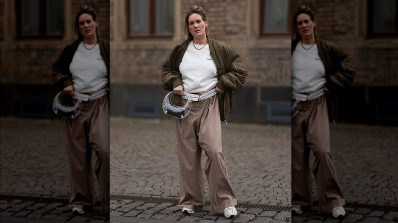 Woman wearing oversized pinstriped pants