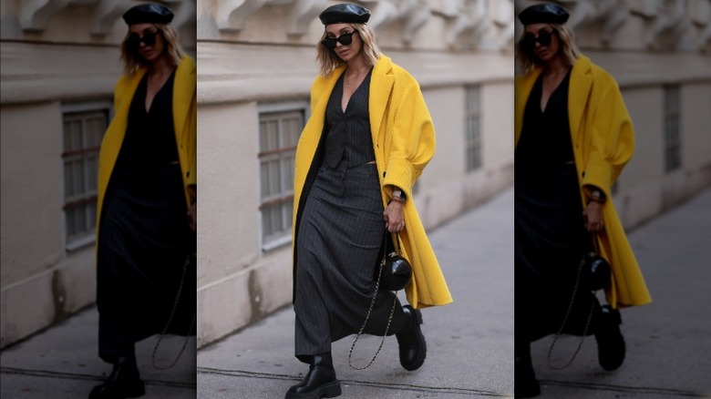 Woman wearing pinstriped skirt, coat
