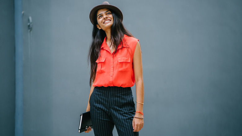 Woman wearing pinstriped pants, sleeveless top