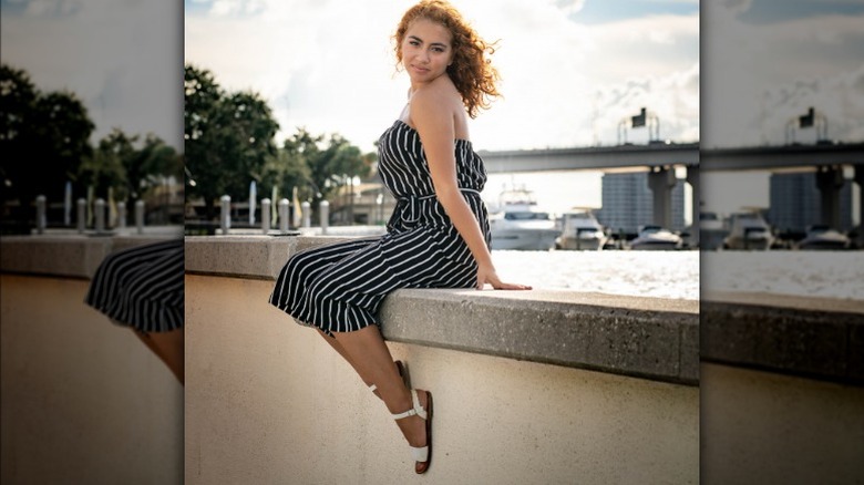 Woman wearing belted pinstriped dress