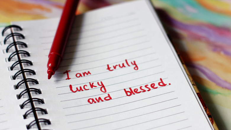 Notebook and pen with affirmation