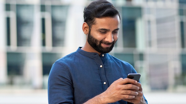 man texting and smiling 