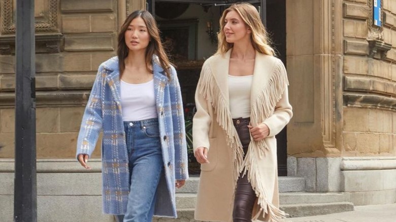 Two one women cross the street