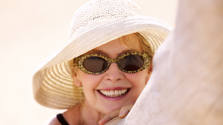 Woman wearing red floppy hat