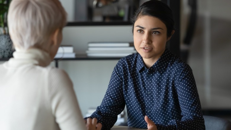 Two women talking at table