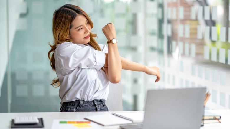 woman stretching at desk