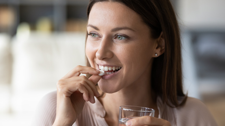 woman taking pill