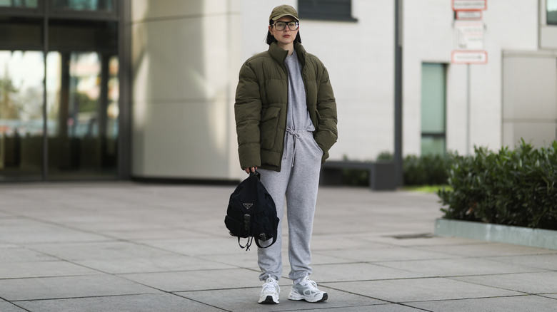 Woman wearing sweatsuit under puffer coat