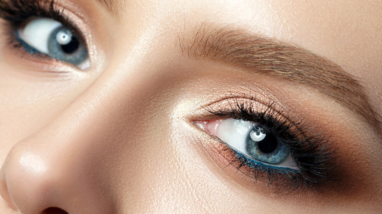 woman wearing gold makeup