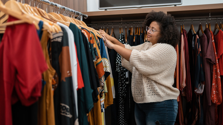 A woman picking out her outfit