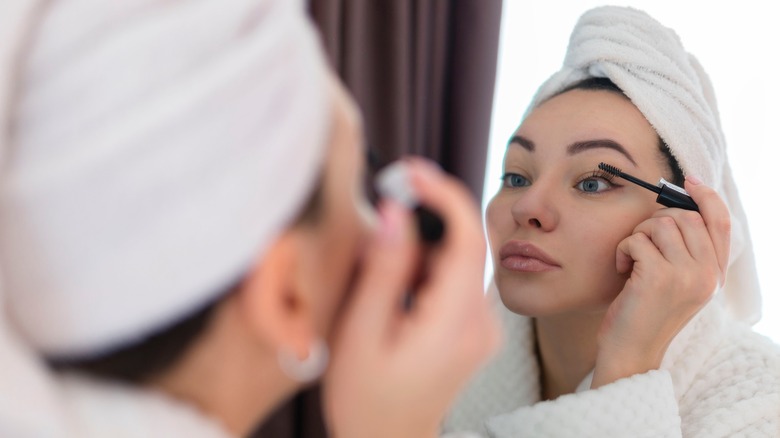 Woman applying mascara