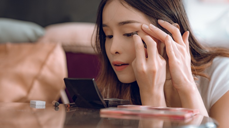 Woman applying eyeshadow