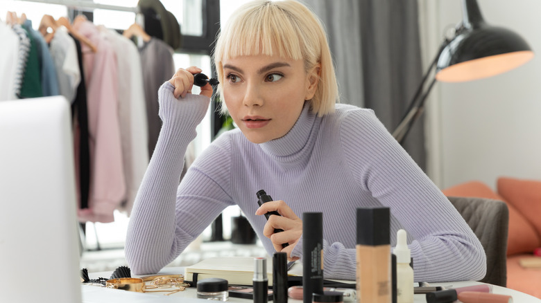 Woman applying mascara