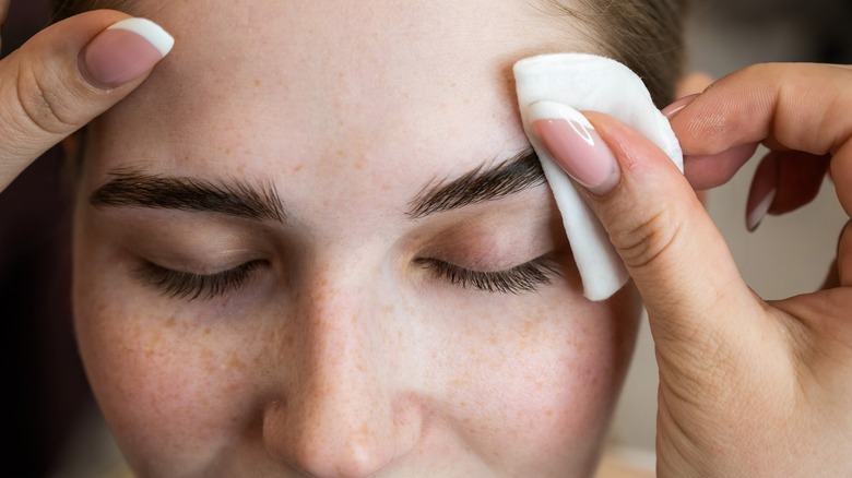 A woman drying her eyebrows