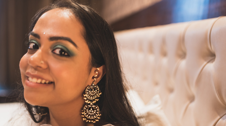 A woman wearing heavy earings