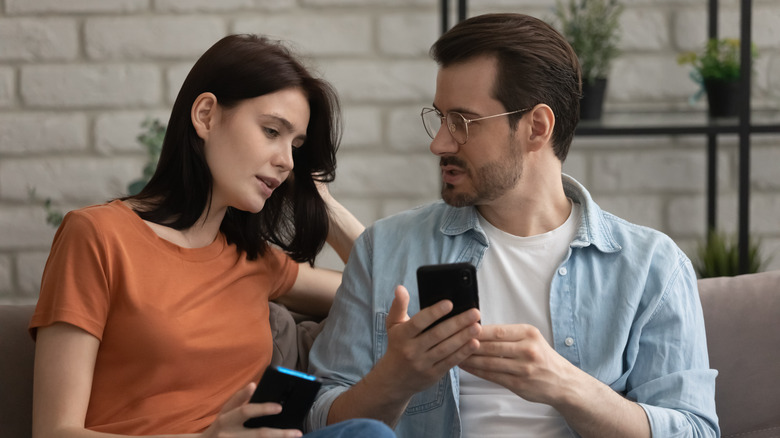 couple talking about phones