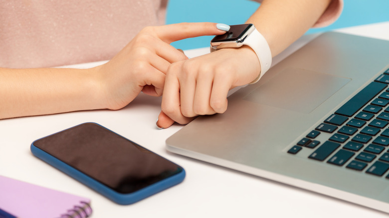Woman silencing alarm on watch