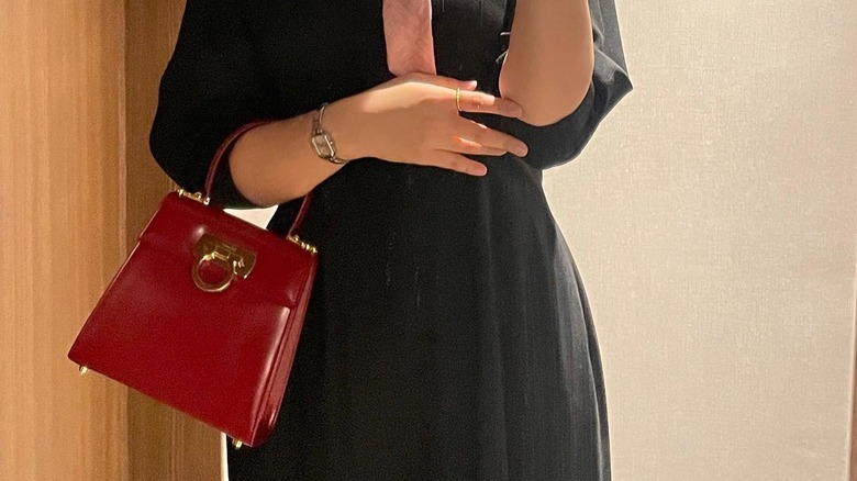 Girl carrying a trapezoid top-handle