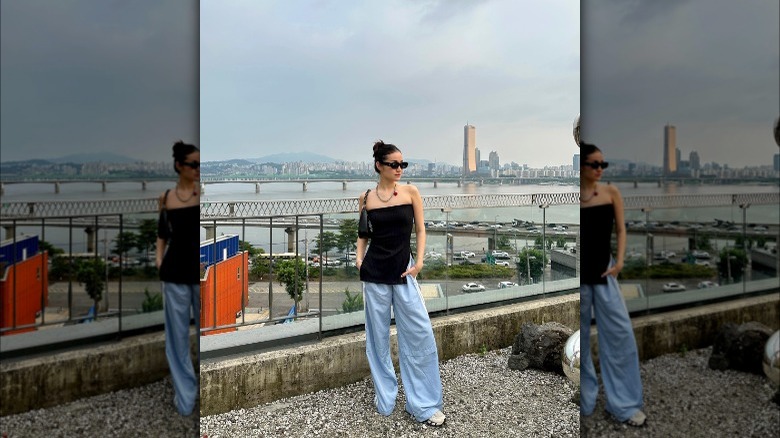 Girl wearing colorful track pants.