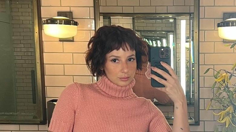 Person with short red hair in pixie-like cut