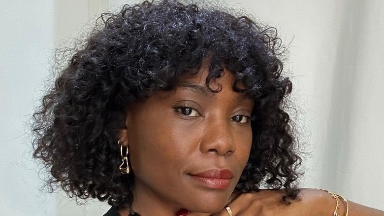 Person with short curly bob and bangs