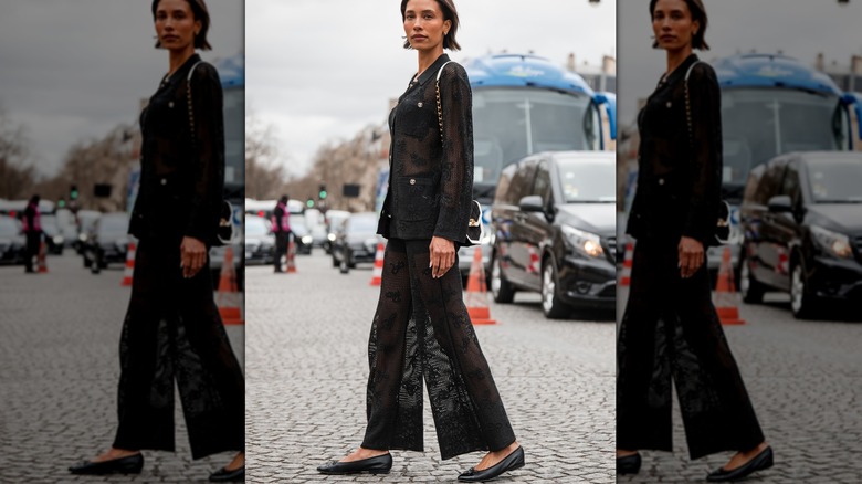 Woman crossing street in all-black outfit