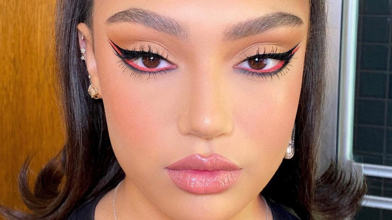 Woman models tri-liner makeup