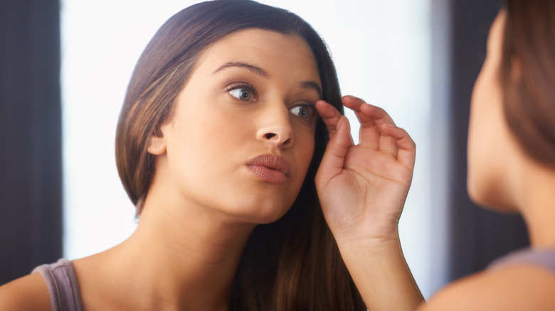 Person curling eyelashes