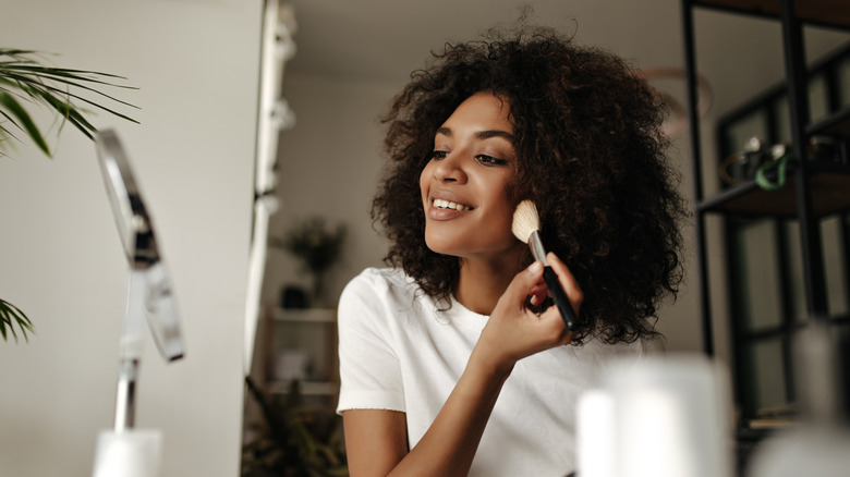 woman applying makeup